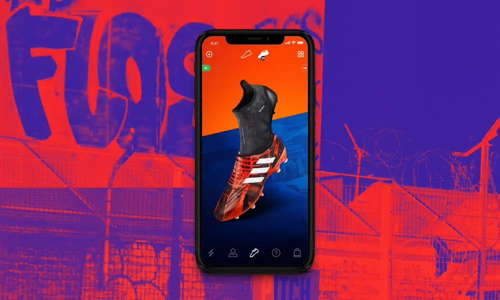 The Adidas GLITCH app on a phone, showing a football boot